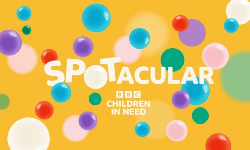 Children in Need 'Spotacular' Logo. Colourful bubbles on a bright yellow background with 'Spotacular' in white text.